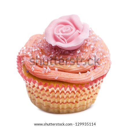 Cupcake with pink flower decoration against white background in front of white background