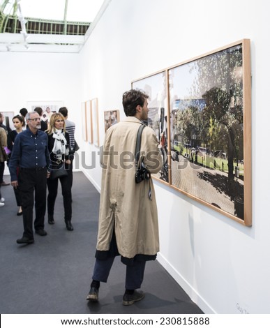 People looking at a photo at Paris Photo art fair 2014, Paris, France