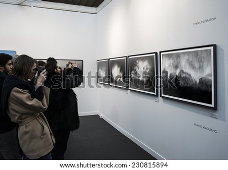 People taking a photo of a photo of huang xiaoliang at Paris Photo art fair 2014, Paris, France
