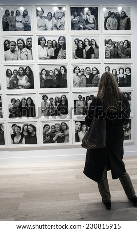 People looking at a photo of Nicholas Nixon at Paris Photo art fair 2014, Paris, France