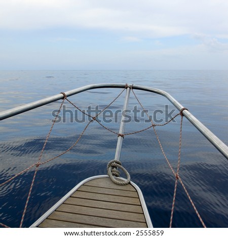 view of boat cruising in the sea. We can see the horizon over the deck