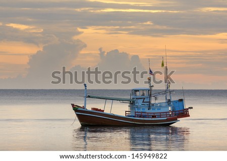 Thai fishing boat used as a vehicle for finding fish in the sea.at sunset