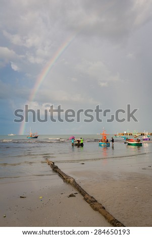 boat by the huahin beachside during beautiful sky with rainbow