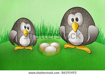 Penguins with  eggs recycled paper craft on paper background