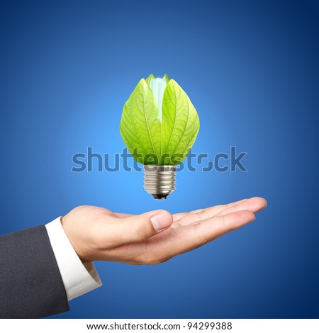 Concept of energy saving light bulbs on Business hand