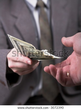man in suit giving 1000 dollars another man