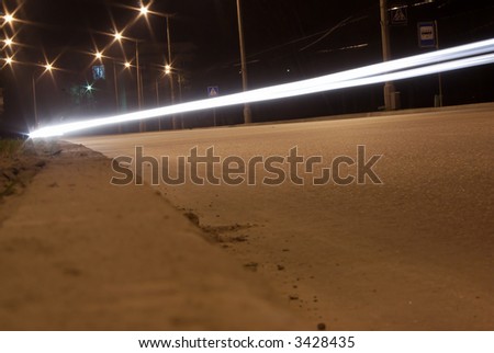 night traffic blurs with road and lamps