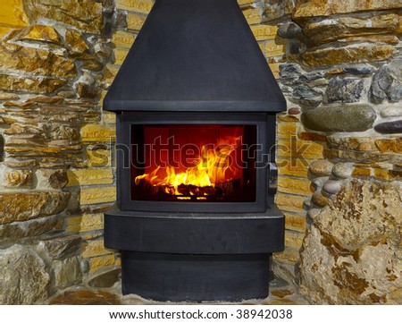 fireplace and fire with stone walls