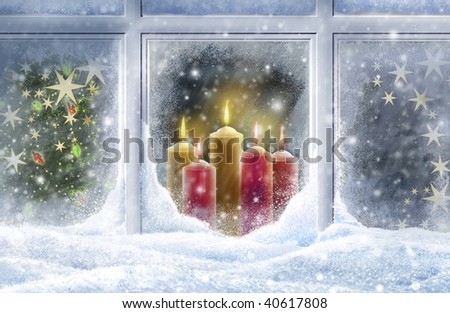 Looking through a snowy window at candles