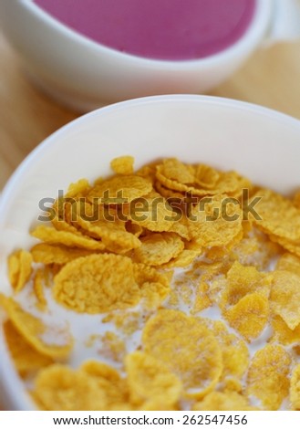 A country breakfast with blueberry  yogurt,, milk and cornflakes in vintage style