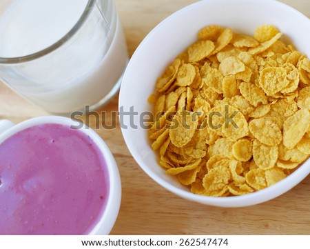 A country breakfast with blueberry  yogurt,, milk and cornflakes in vintage style