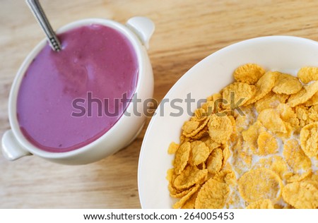 A country breakfast with blueberry  yogurt, milk and cornflakes in vintage style