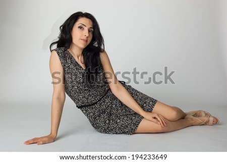 young woman in casual dress siting