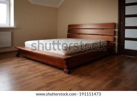 Interior bedroom. Wooden bed mattress.