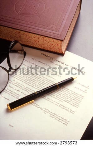 Book, pen and Power of Attorney document on a desktop