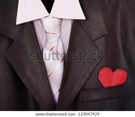 Closeup man suit with red paper heart in the pocket
