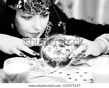 Black and white portrait of fortune-teller with chrystal ball