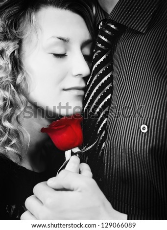 Black and white photo of woman and man with red rose