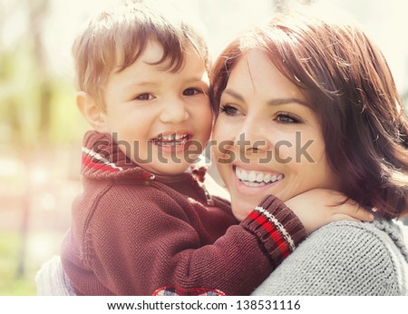 Happy laughing woman with her little son outdoors
