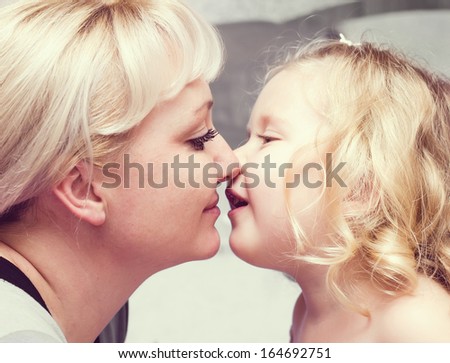 Daughter kissing her  Mother