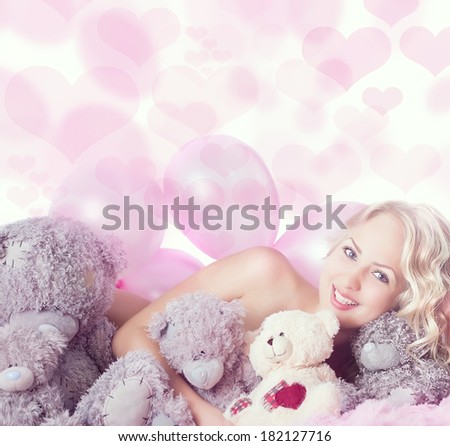 Naked young woman with toy bears and balloons