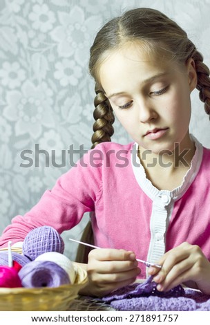 Portrait of knitting little girl