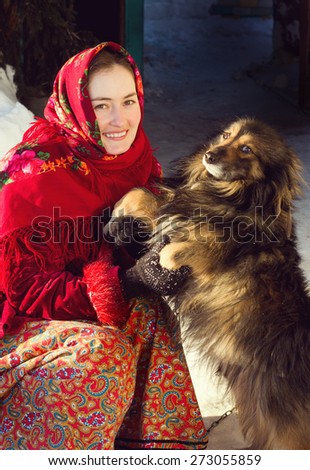 Russian woman in ethnic costume with dog