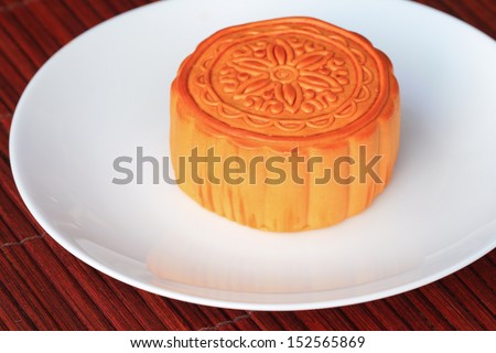 Chinese Moon cake on white dish , Chinese tradition. (the pattern on moon cake is not a logo or trademark)