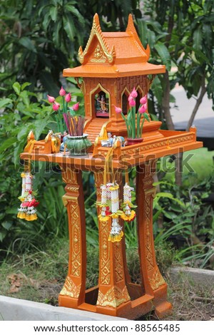 Thai outdoor spirit house shrine. In modern Thailand all spirit houses are kept outdoor.  This one is made in the Thai Buddhist temple (wat) style.