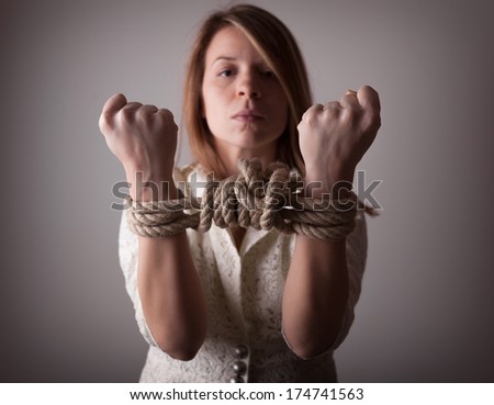 Young woman with tied hands