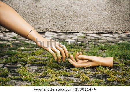 Weathered hands of plastic mannequin doll. Helping hand.