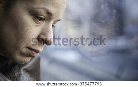A woman in streetcar alone and depressed