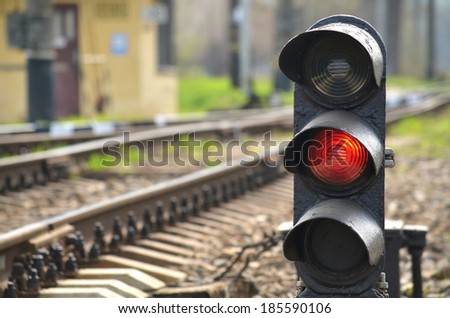 Traffic light shows red signal on railway. Red light