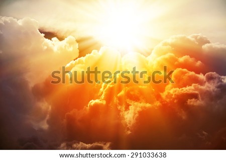 The bright rays of the sun are shining from saturated clouds