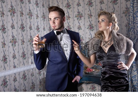 Angry husband and his wife having argue in posh, luxury apartment