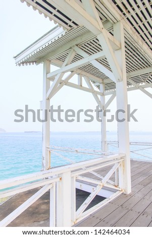 The wooden terrace beside the beach with clear sea