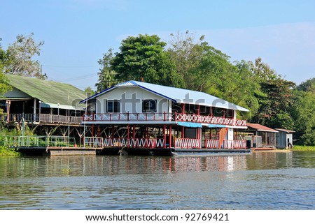 Colorful floating house or houseboat floating on the river.