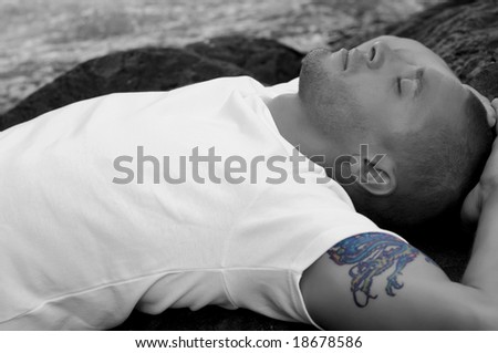 young sexy caucasian man in black and white, with colored tattoo