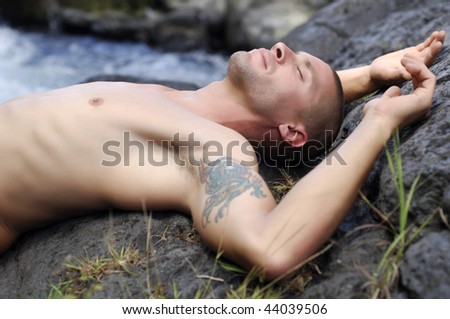 Portrait of young french man sleeping on rock