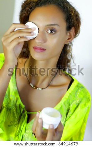 Young mixed woman on make-up removal