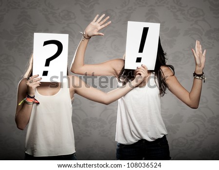 young women with interrogation and exclamation symbols in front of their faces