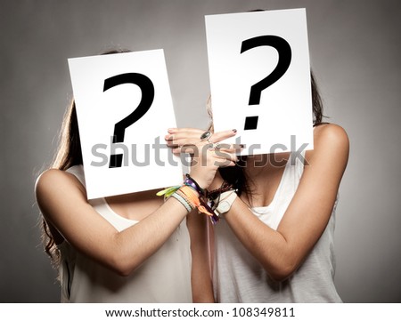 young women with interrogation symbols in front of their faces
