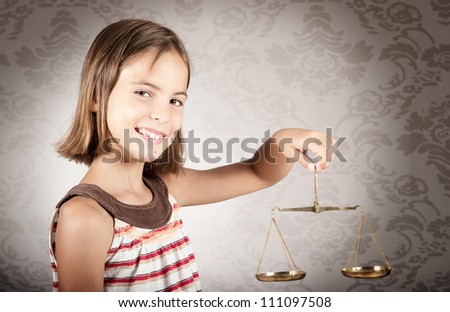 little girl holding justice scale