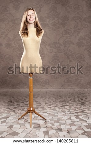 portrait of young woman with old mannequin body