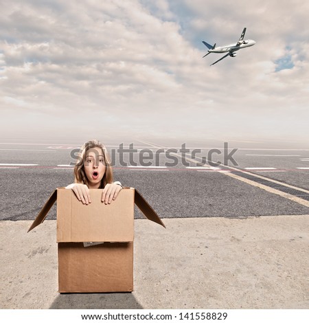 young woman inside a box at airport