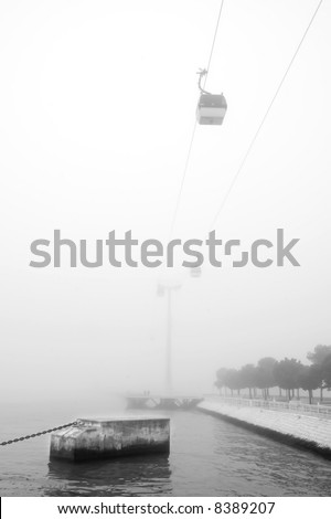 cable-way near river Tagus, in Lisbon, Portugal in a winter misty day