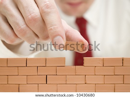 businessman building a wall
