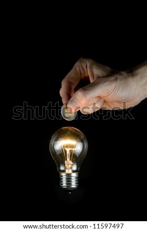 putting money in a light bulb. Saving energy