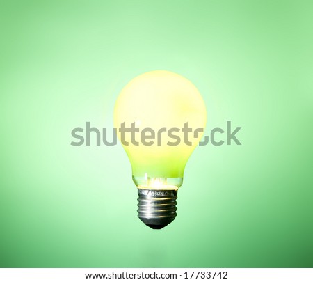 green light bulb on green background
