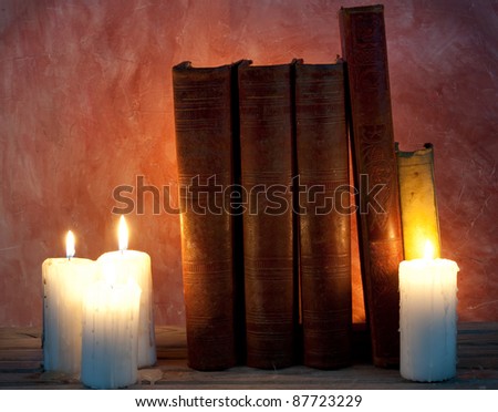 ancient books with candle lights